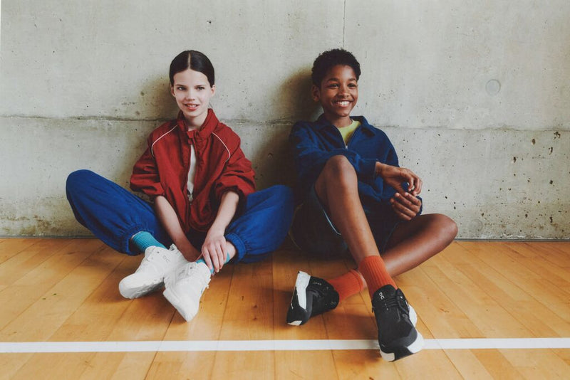 on running shoes worn by a female and male child