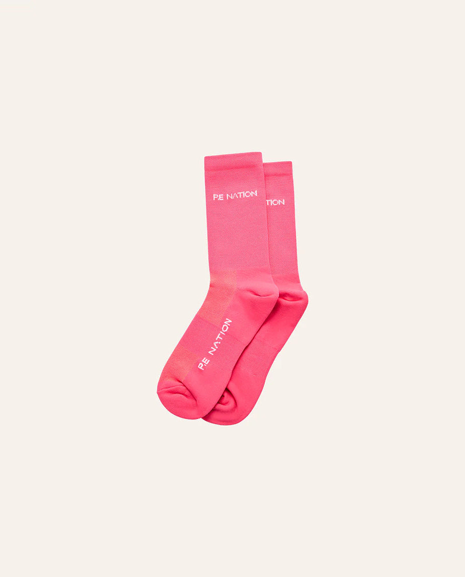 Pair of pink socks with text on a light beige background