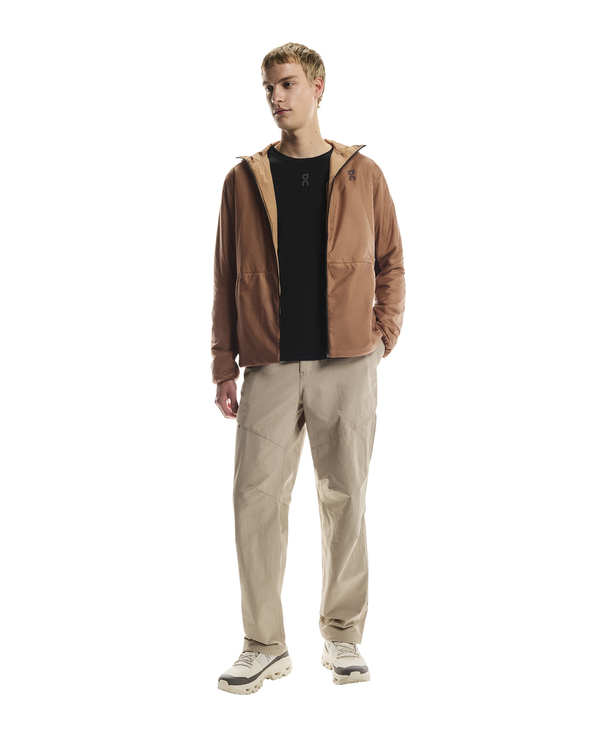 MAN WEARING Men's On Running Desert Water Resistant Trek Pants with matching on running jacket