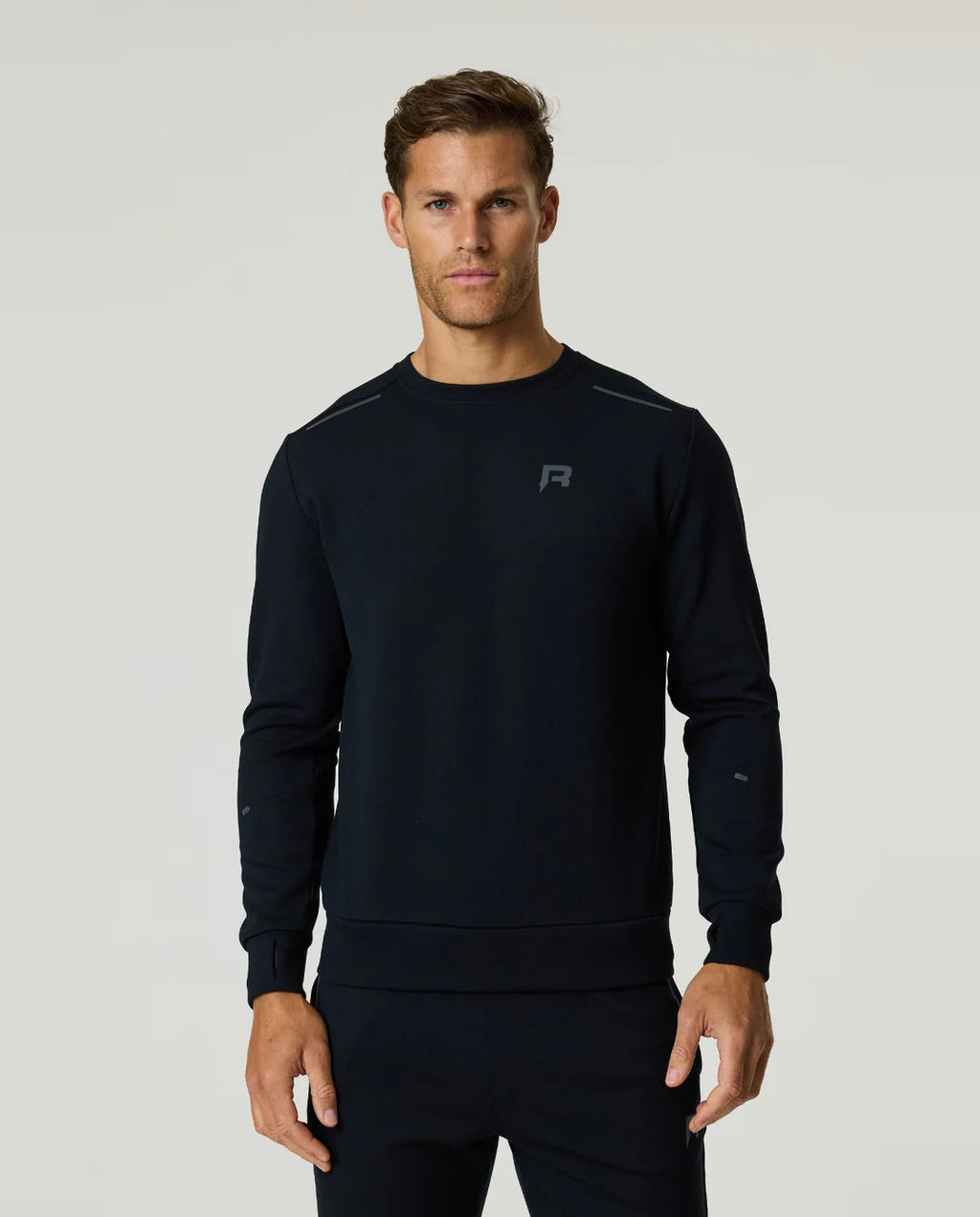 Men's Reprimo Black Motion Crew Neck Jumper with chest reflective logo and reflective strips styled with matching tracksuit pant