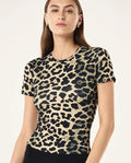 Woman wearing a leopard print top against a plain background