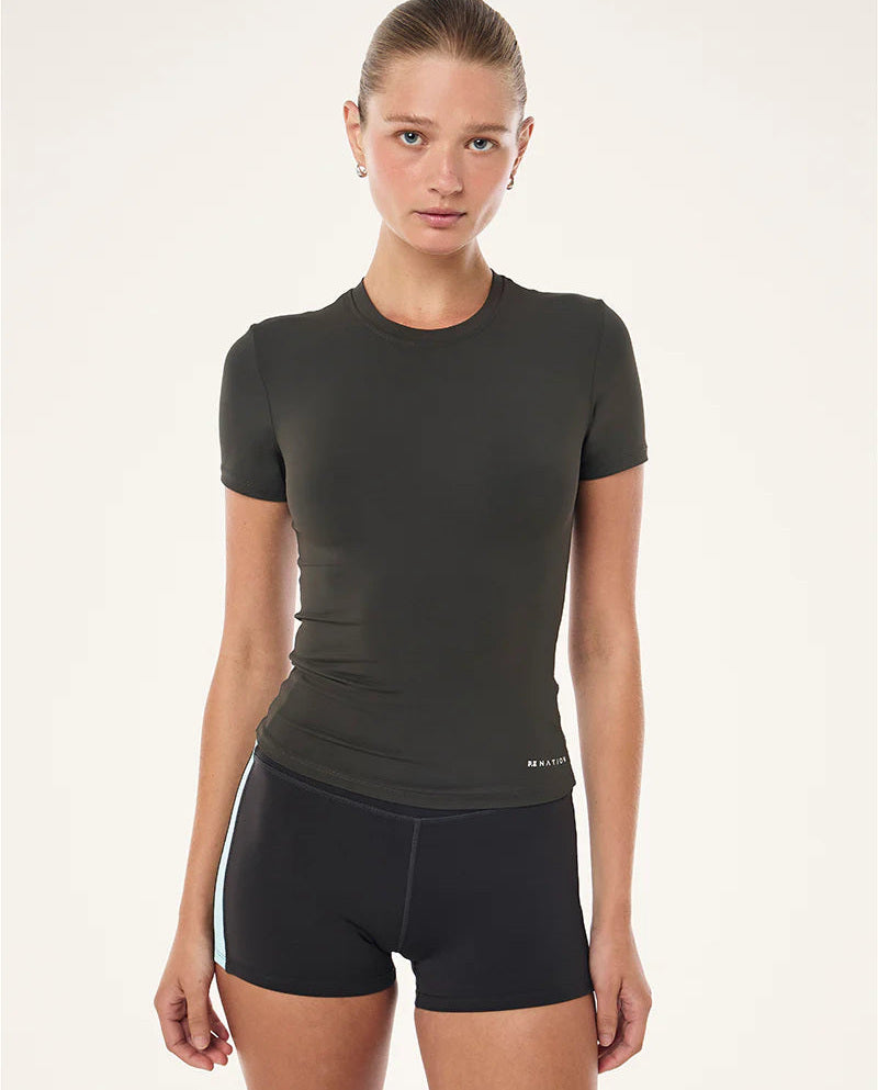 Woman wearing a black athletic outfit on a white background