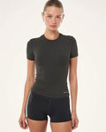 Woman wearing a black athletic outfit on a white background