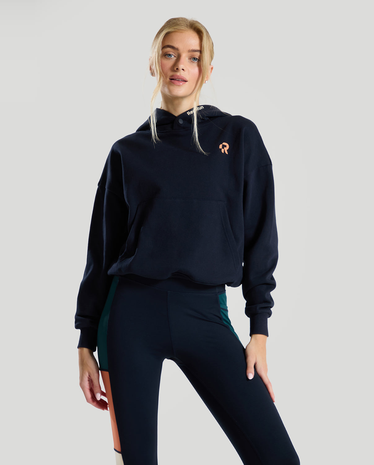 navy blue hoodie by red run on a grey background