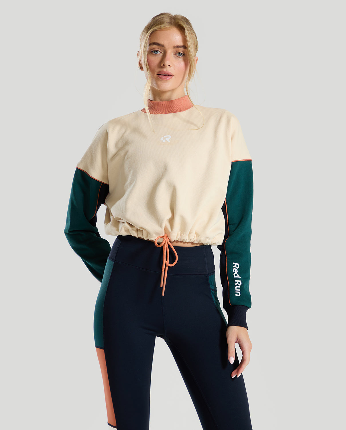 female model wearing a cream & green red run sweater 