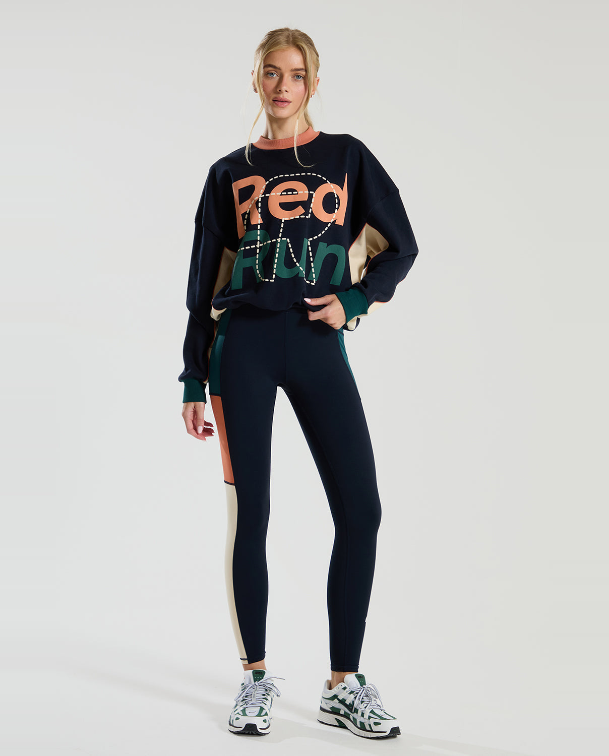 female model in a long sleeve crew neck navy red run sweater