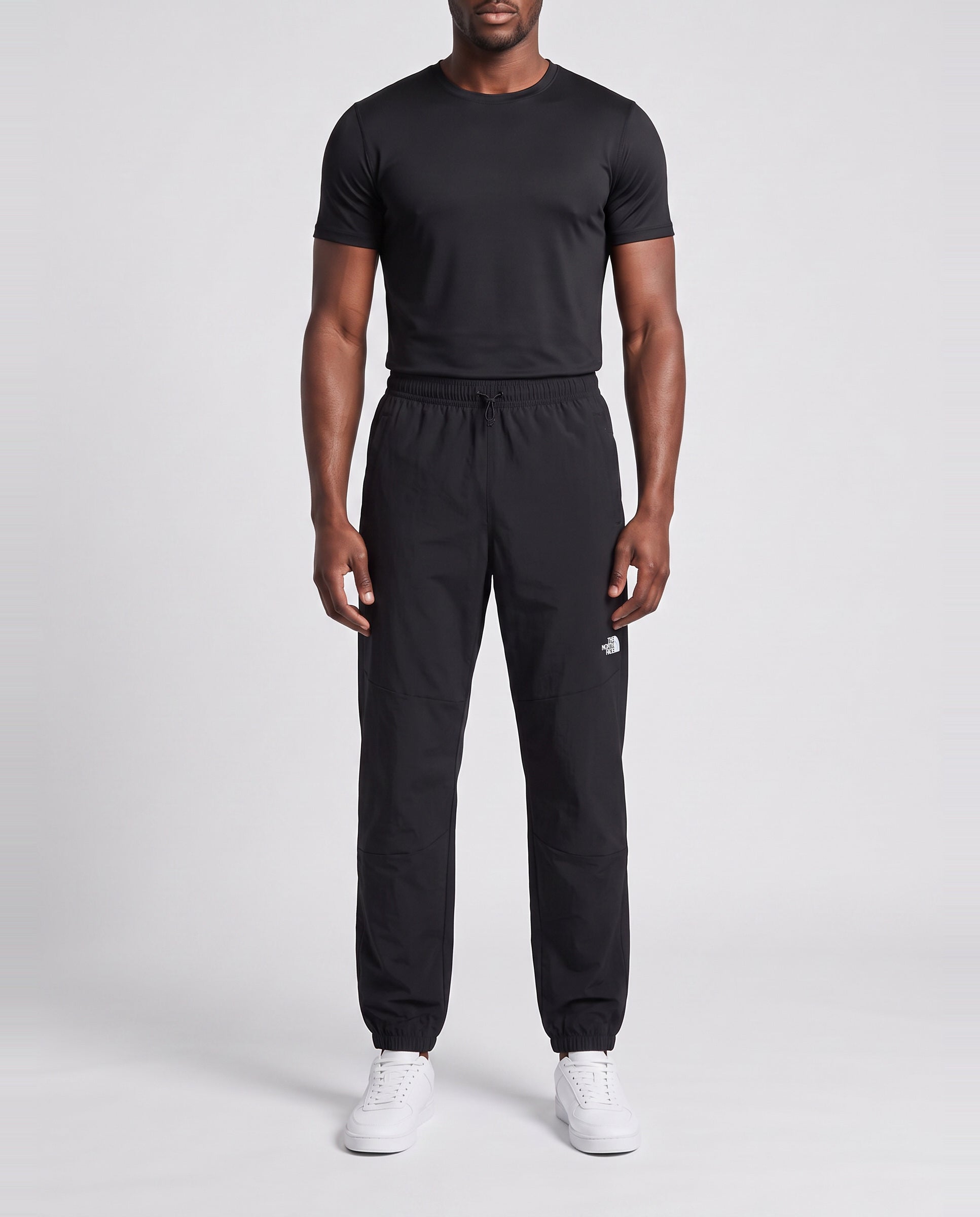 Men's The North Face Black Mountain Athletics Wind Pant — on model