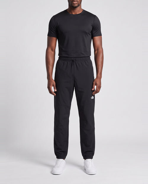 Men's The North Face Black Mountain Athletics Wind Pant — on model