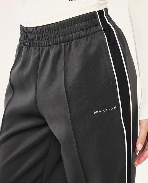 Black pants with white stripes and 'PE NATION' branding on a white background