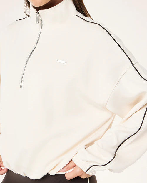 White jacket with black accents worn by a person on a white background