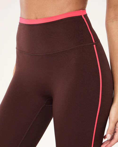 Brown leggings with pink accents on a white background