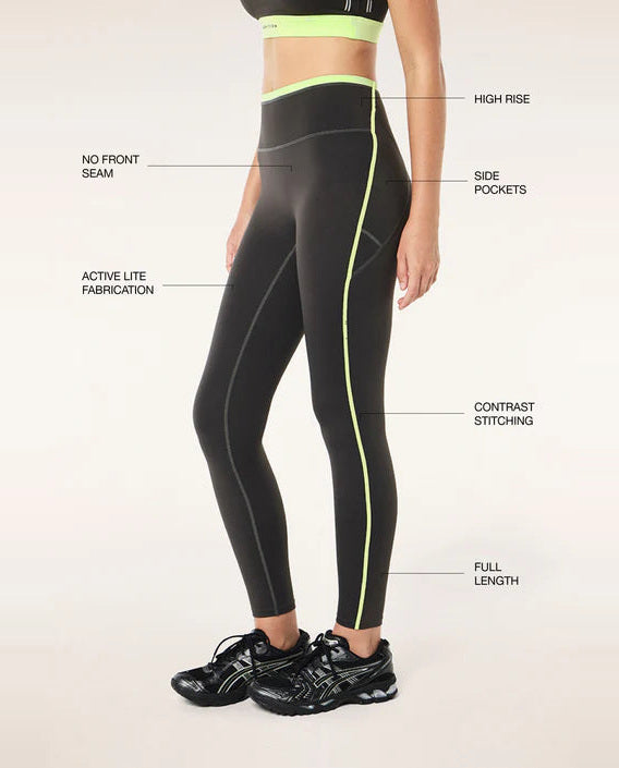 grey leggings with green accents on a white background, featuring text labels.