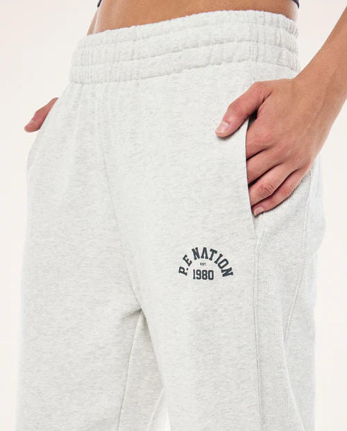 White sweatpants with 'P.E. Nation' logo on a plain background