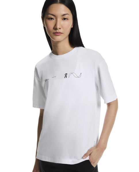 Person wearing a white t-shirt with a logo on a white background