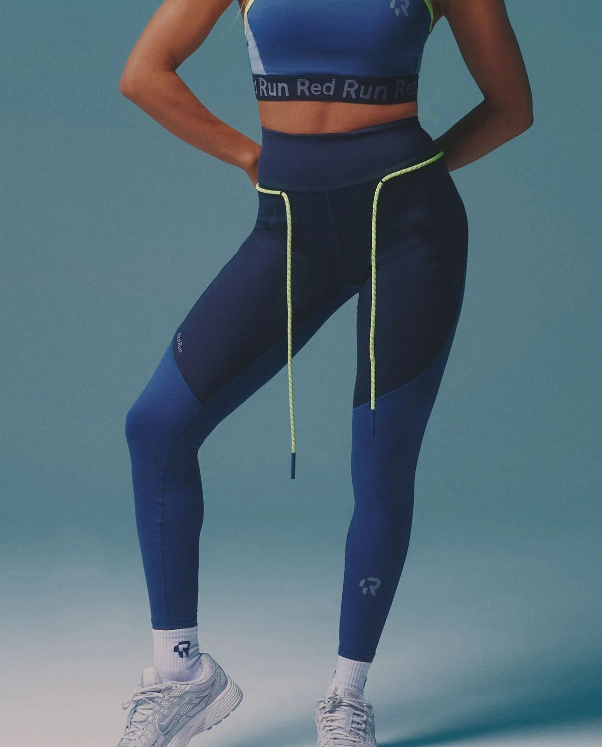 Person wearing a blue athletic outfit with 'Run Red' branding on a gradient background