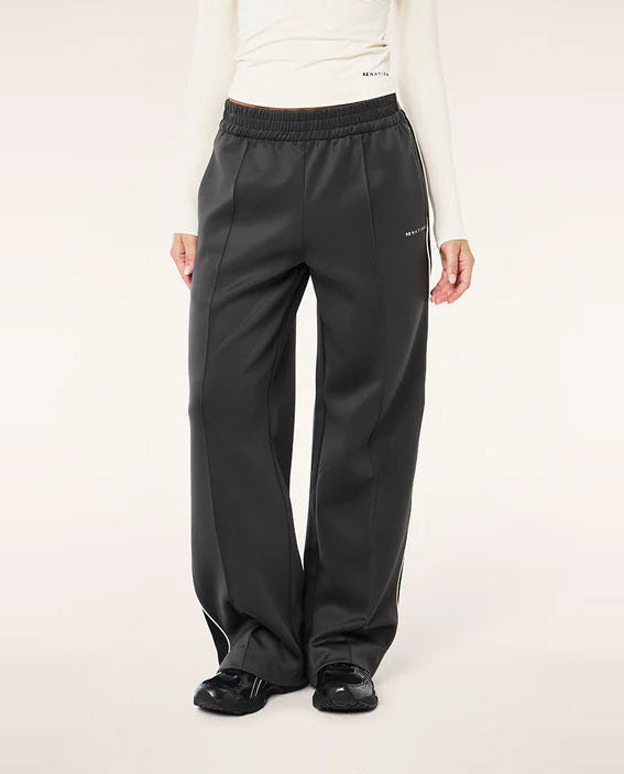 Person wearing black pants with a white background