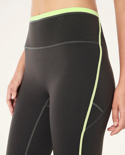 Grey leggings with neon green accents on a white background