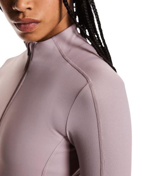Close-up of a person wearing a light purple athletic outfit with a high collar.