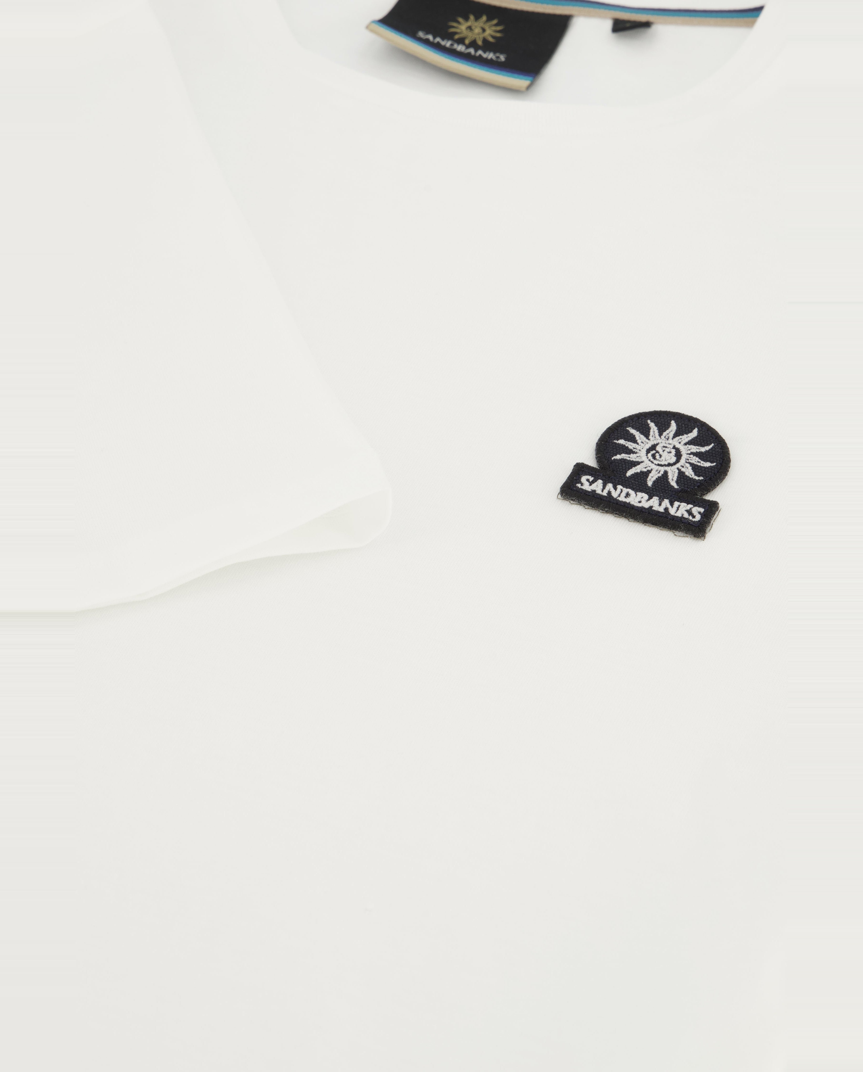 Close up image of Sandbanks logo on white t-shirt