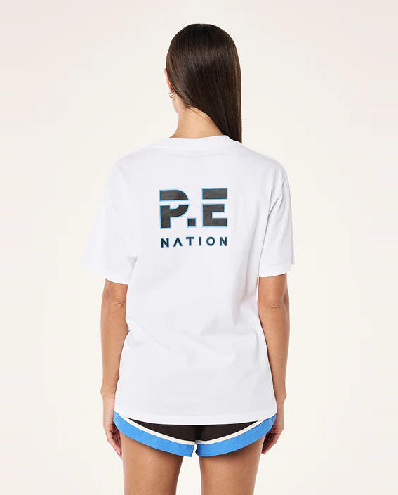Person wearing a white 'P.E. Nation' t-shirt on a plain background