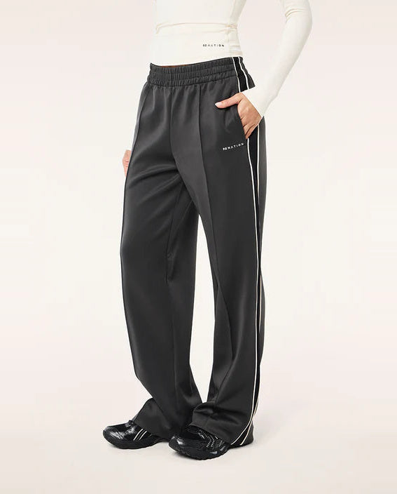 Black track pants with white stripes on a white background