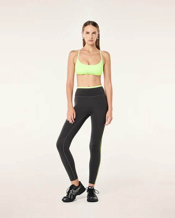 Grey leggings with neon green accents on a white background