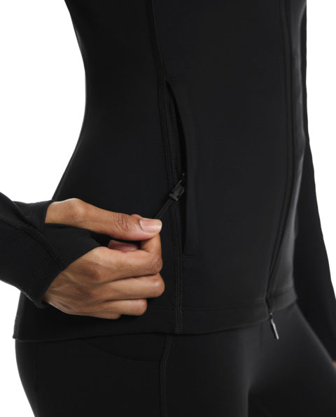 Close-up of a person wearing a black jacket with a hand zipping it up on a white background