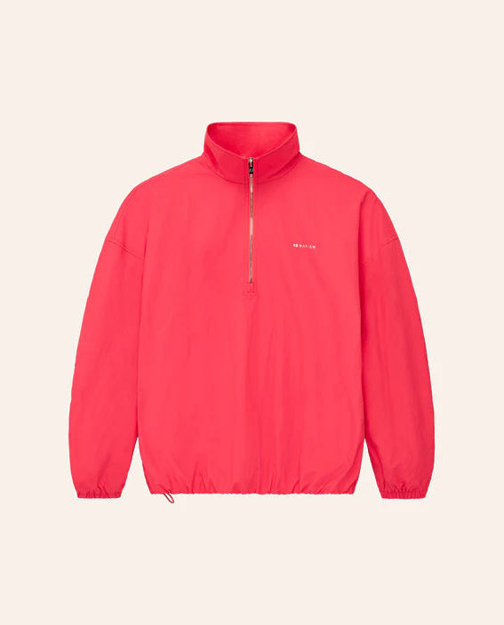 Red jacket with a brand logo on a light beige background