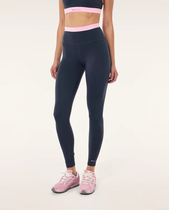 marine blue sports leggings with pink highlights on a model 