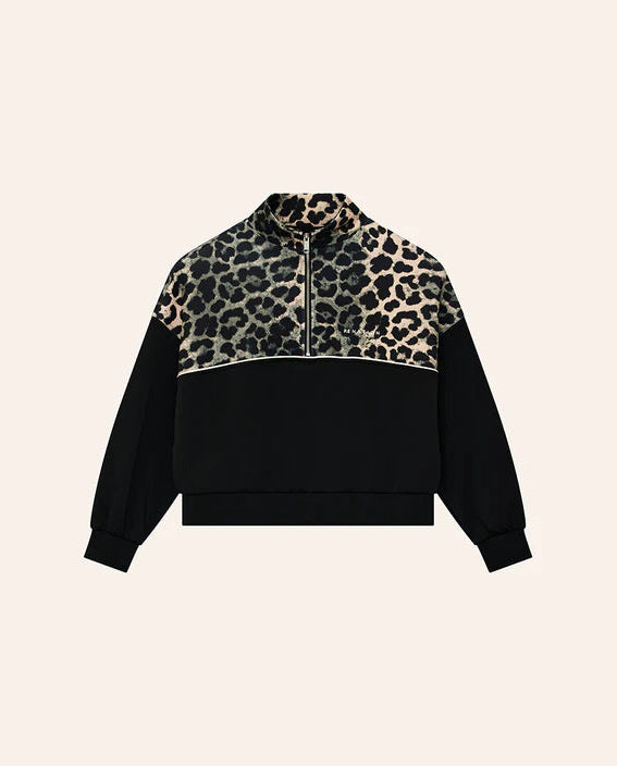 Black and leopard print jacket on a beige background