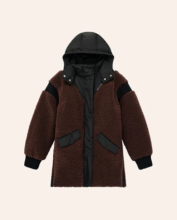 Brown coat with black accents on a beige background