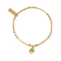 Gold and silver beaded bracelet with moon and sun charm.
