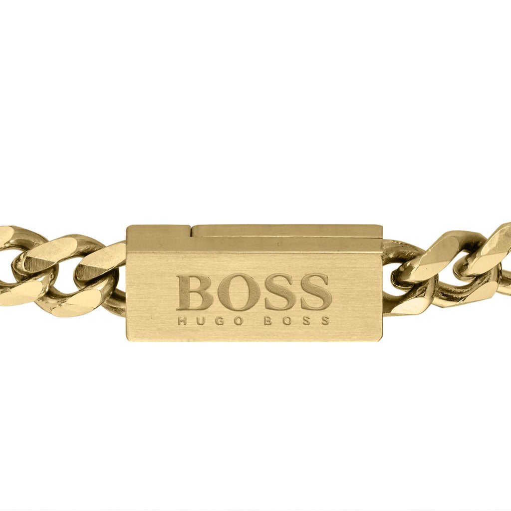Close-up of a BOSS chain bracelet for men in yellow gold-plated links featuring the BOSS Hugo Boss logo clasp.