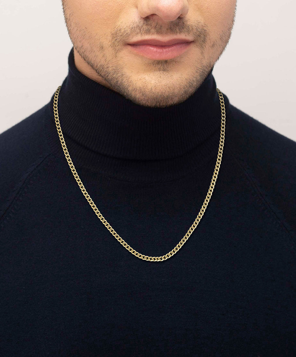Man wearing a gold plated chain necklace, showcasing its style and length. Stainless steel jewelry.
