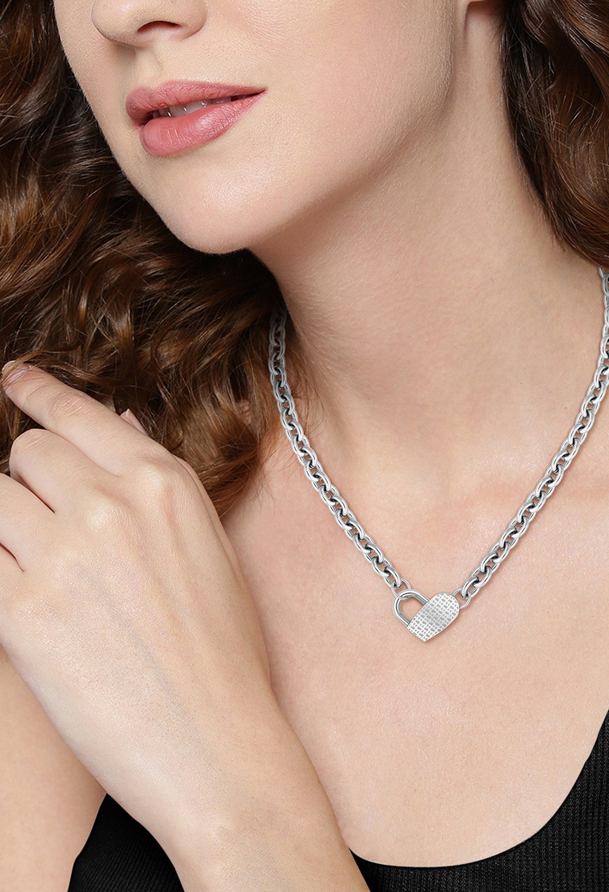 Woman wearing a BOSS heart necklace in stainless steel, showcasing the jewelry's delicate design and elegant style.