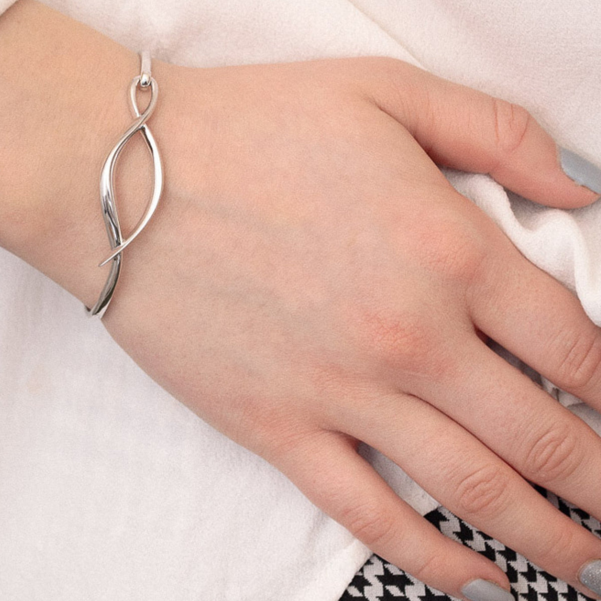 The Kit Heath Entwine Twine Twist Hinged Bangle, a silver bracelet from Kit Heath, available at OD’s Jewellers in St Helens.