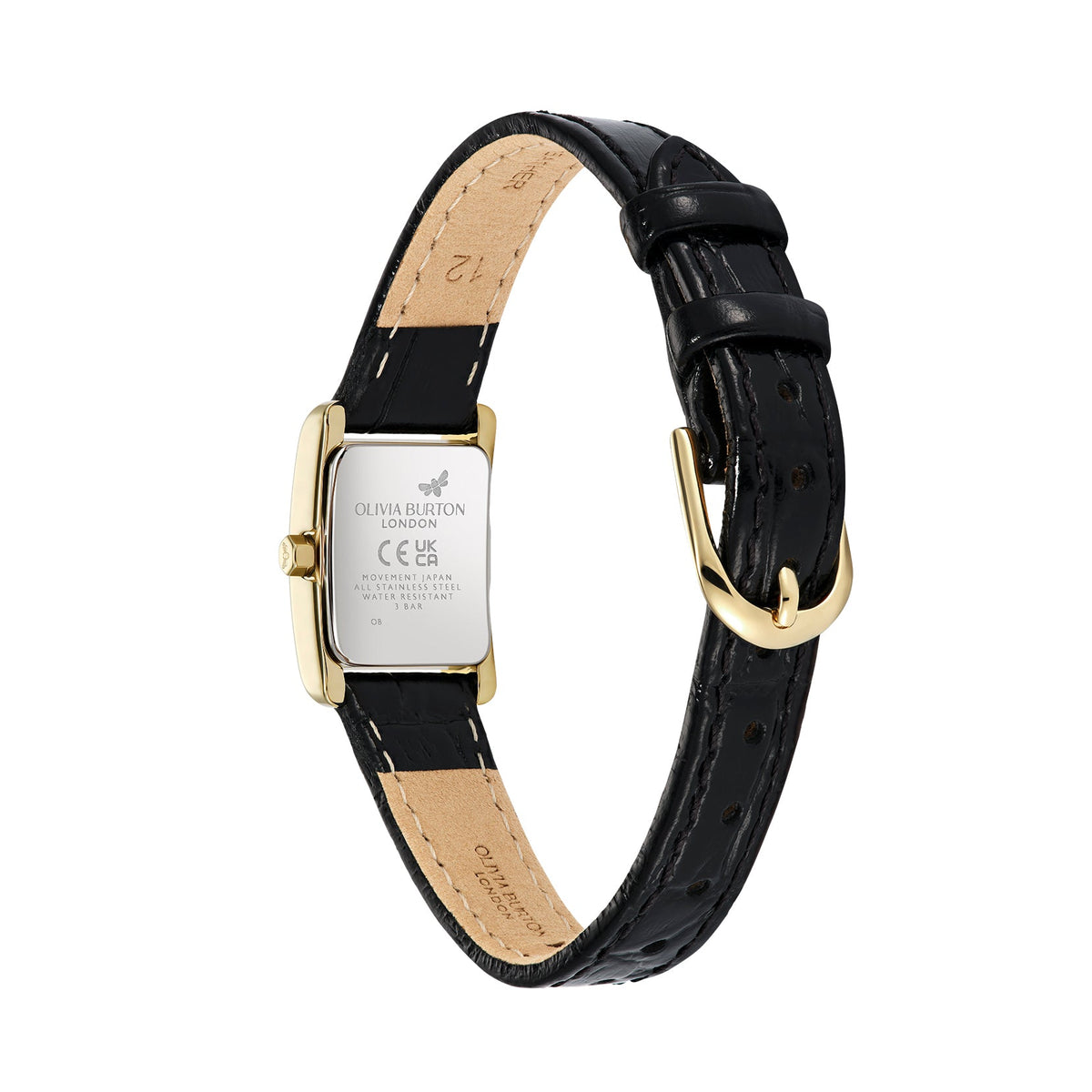 Close-up of the back of an Olivia Burton London wristwatch, featuring a gold-tone rectangular case, a black leather strap with visible stitching, and a gold-tone buckle. The case back has engraved text and symbols, while the strap shows the inner lining and size markings.