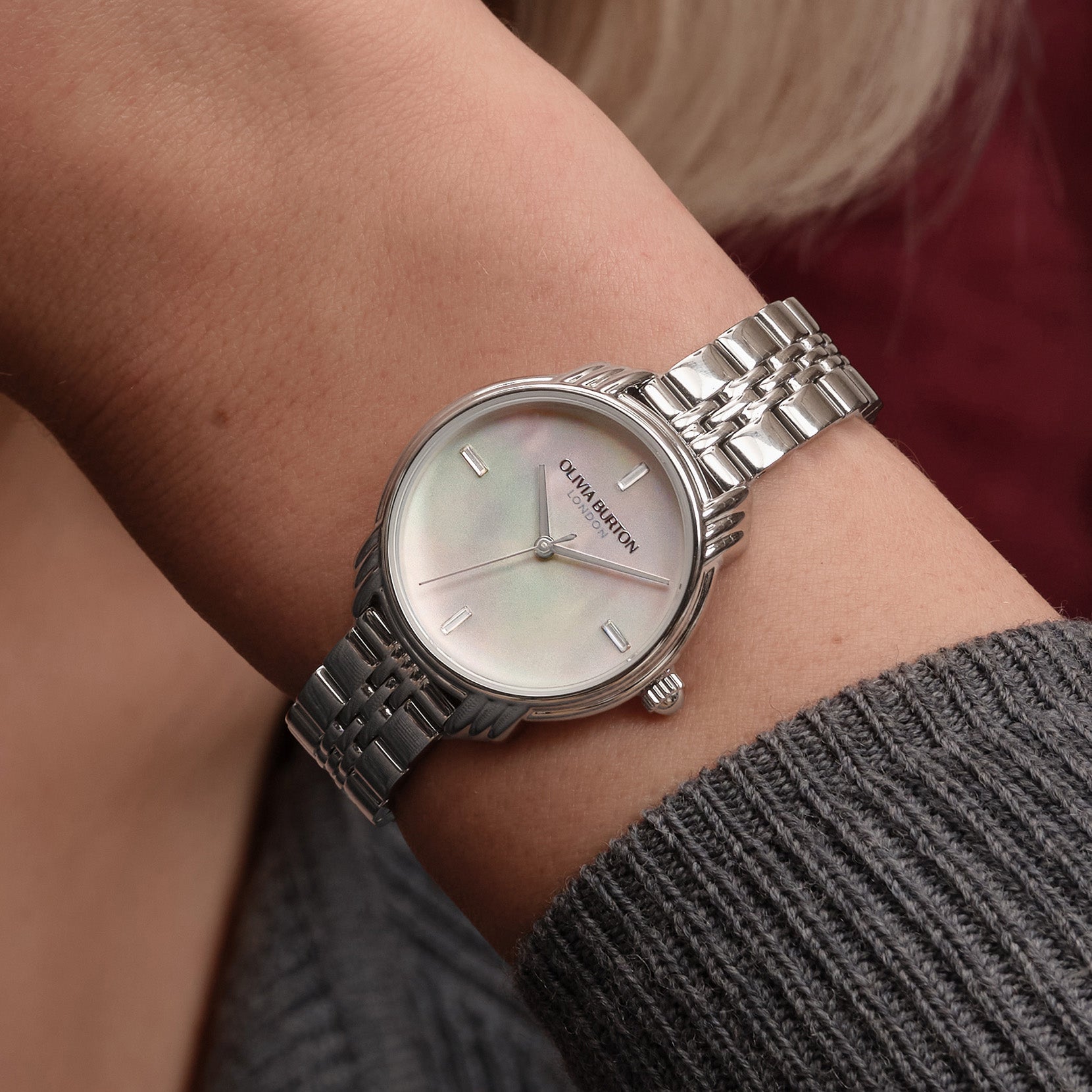 Silver Olivia Burton watch on wrist.

