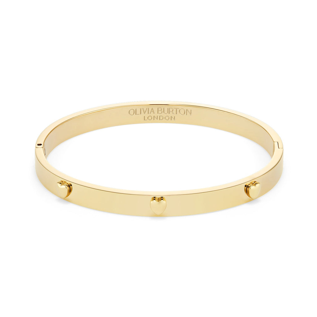 Gold Olivia Burton bangle bracelet with heart details.