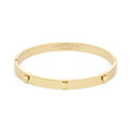 Gold Olivia Burton bangle bracelet with heart details.
