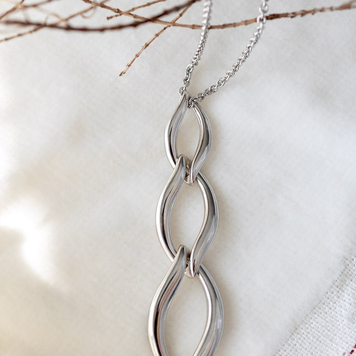 The Kit Heath Entwine Twine Trio Link Necklace, a silver necklace from Kit Heath, available at OD’s Jewellers in St Helens.
