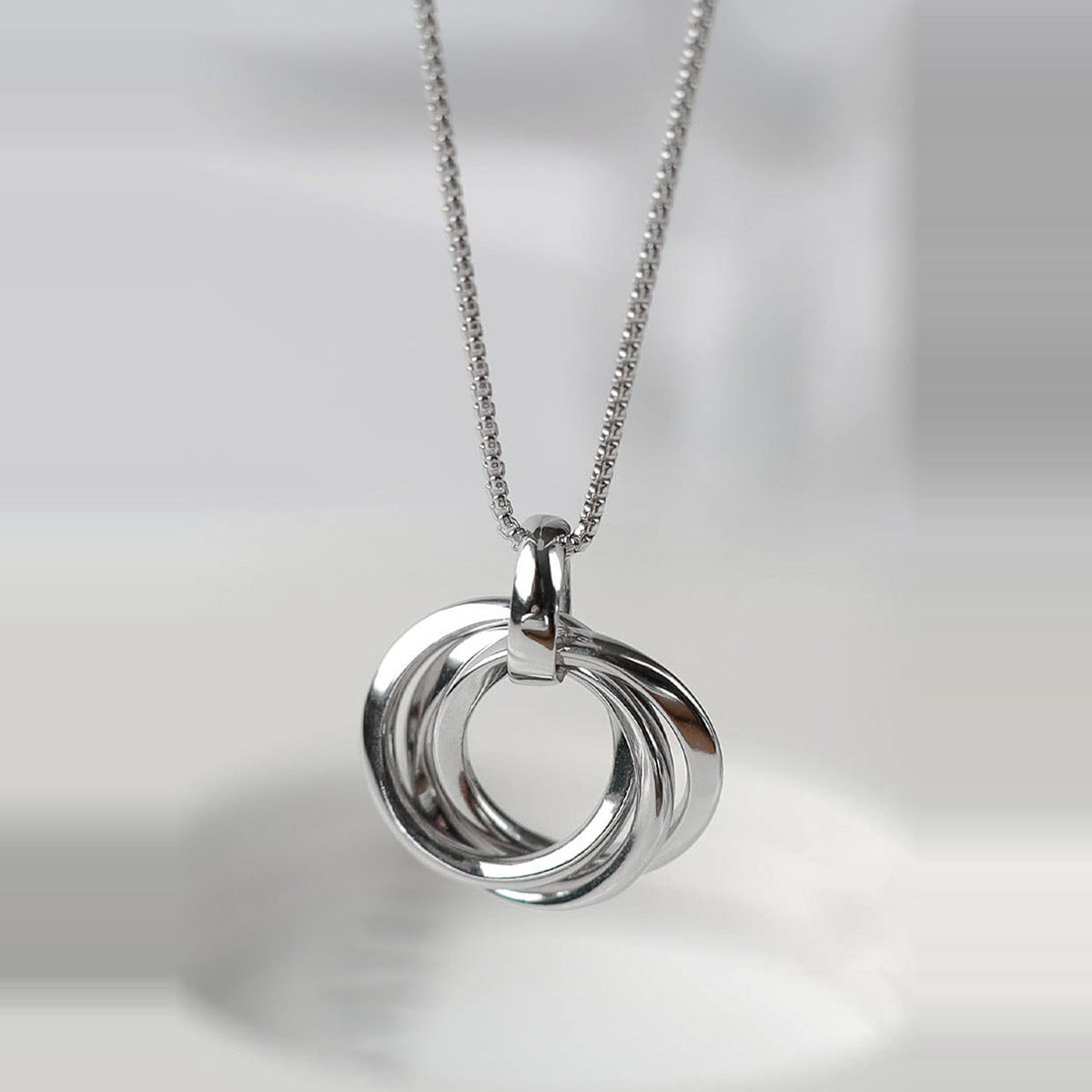 Silver Kit Heath Trilogy Necklace showcasing the interconnected rings pendant with rhodium plating on a delicate chain.