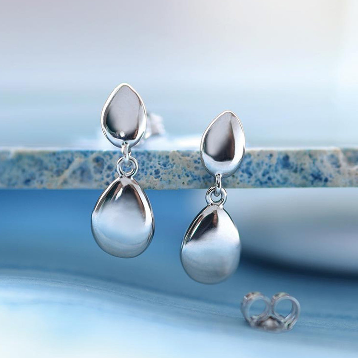 The Kit Heath Coast Pebble Stud With Silver Droplet Earrings, a silver metal earrings from Kit Heath, available at OD’s Jewellers in St Helens.