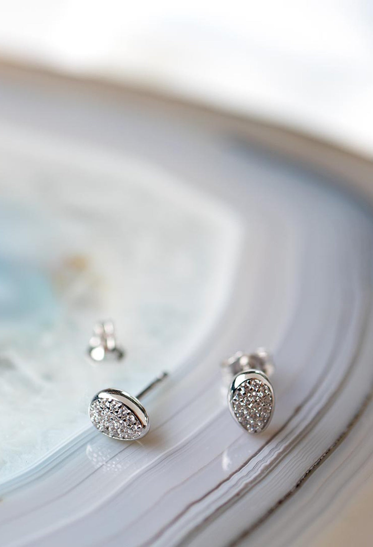 Silver stud earrings featuring pave CZ detail, highlighting the Glisten design of the Kit Heath Coast Pebble collection.