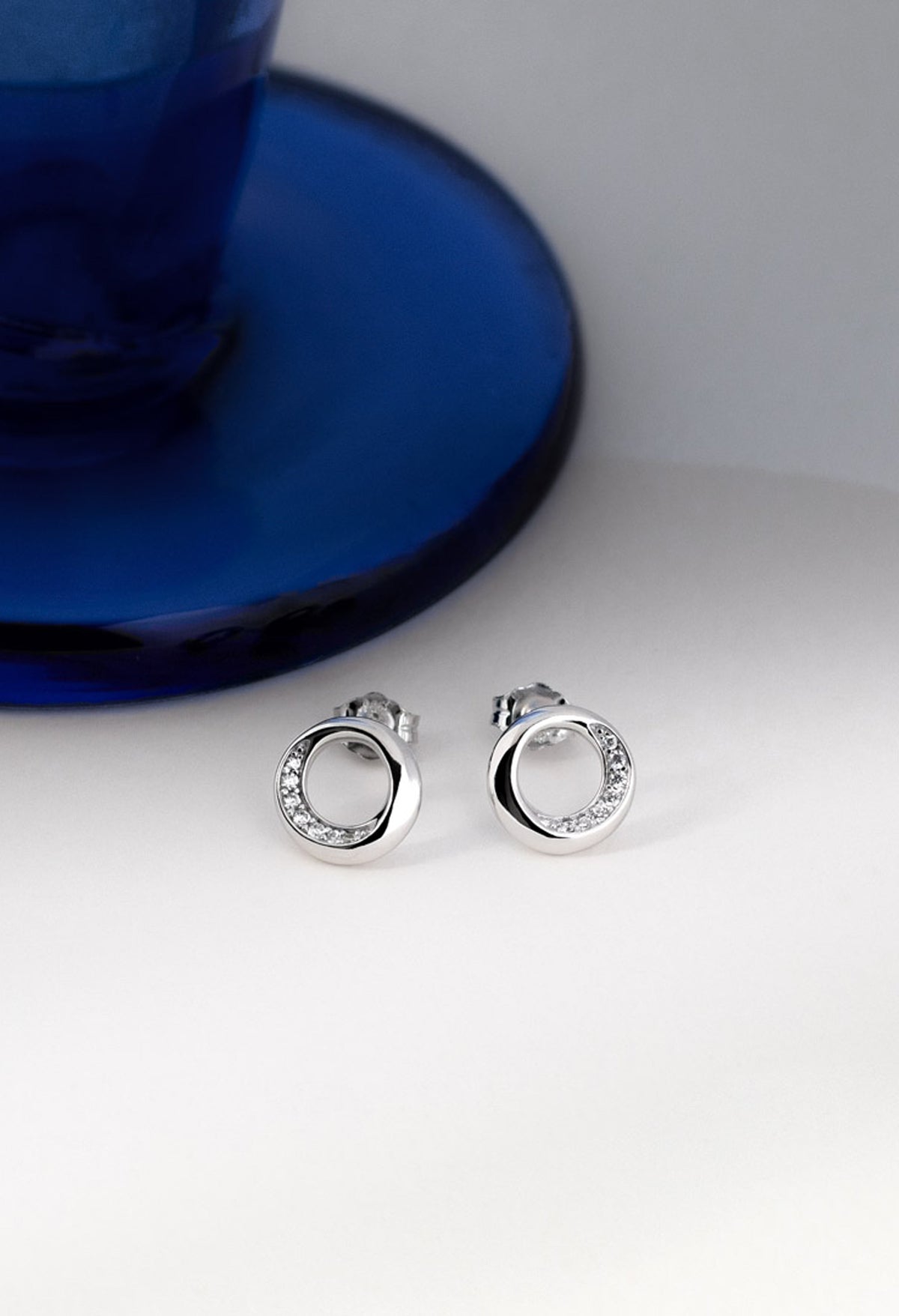 Close-up of Kit Heath Bevel Cirque stud earrings. Sterling silver with pave cubic zirconia stones for subtle sparkle.