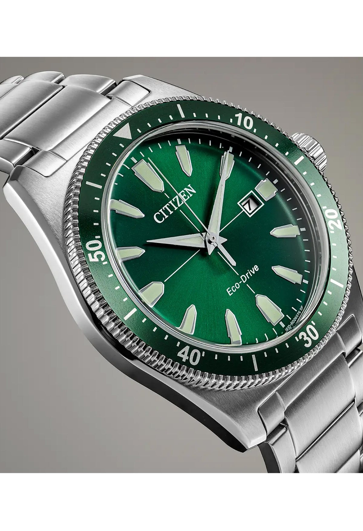 Close-up of the Citizen Eco-Drive Sport watch, showcasing the green dial, date display, & stainless steel band. Model: