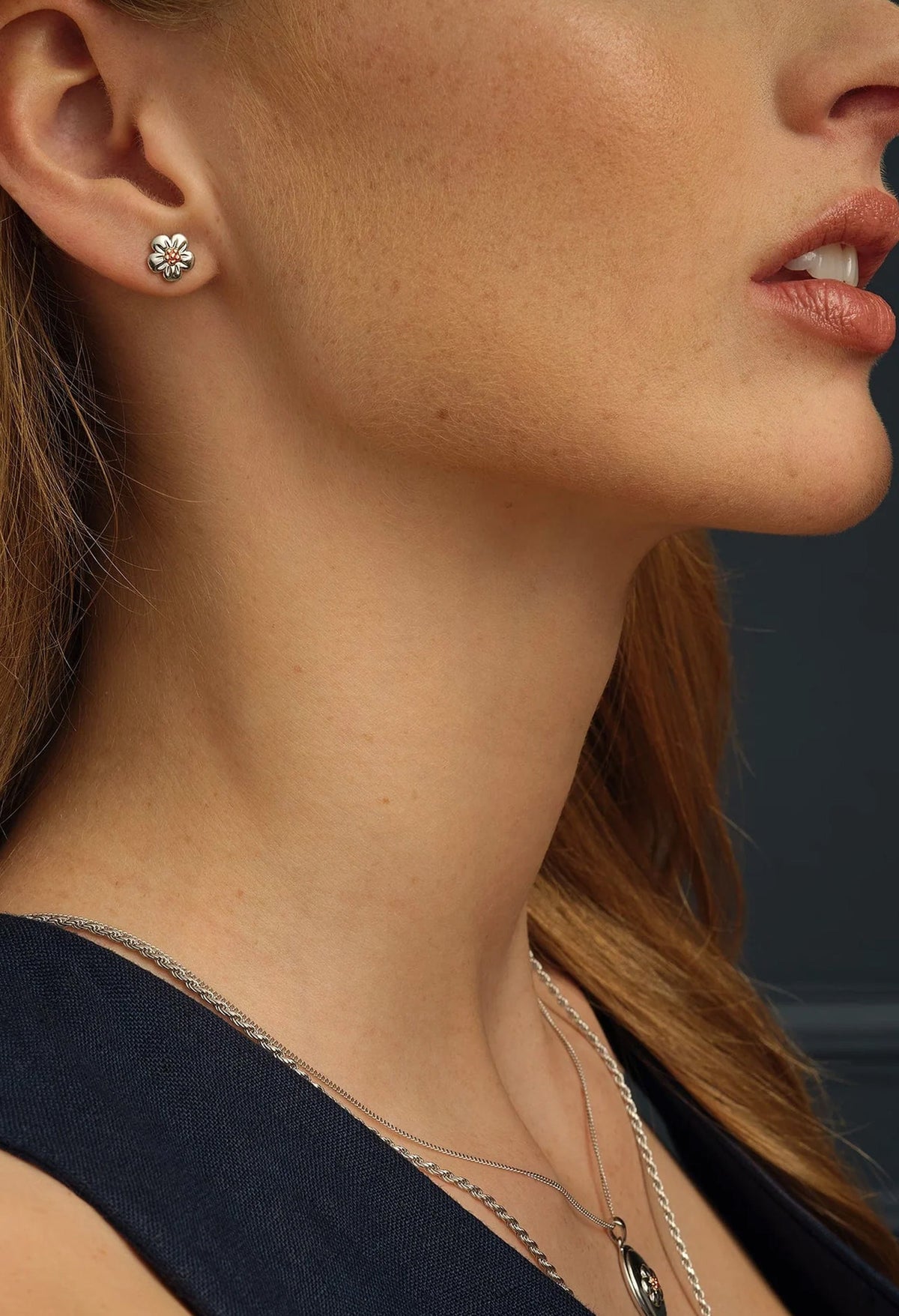 Sterling silver Forget Me Knot stud earrings from Clogau, showcasing the earring's design on a model.