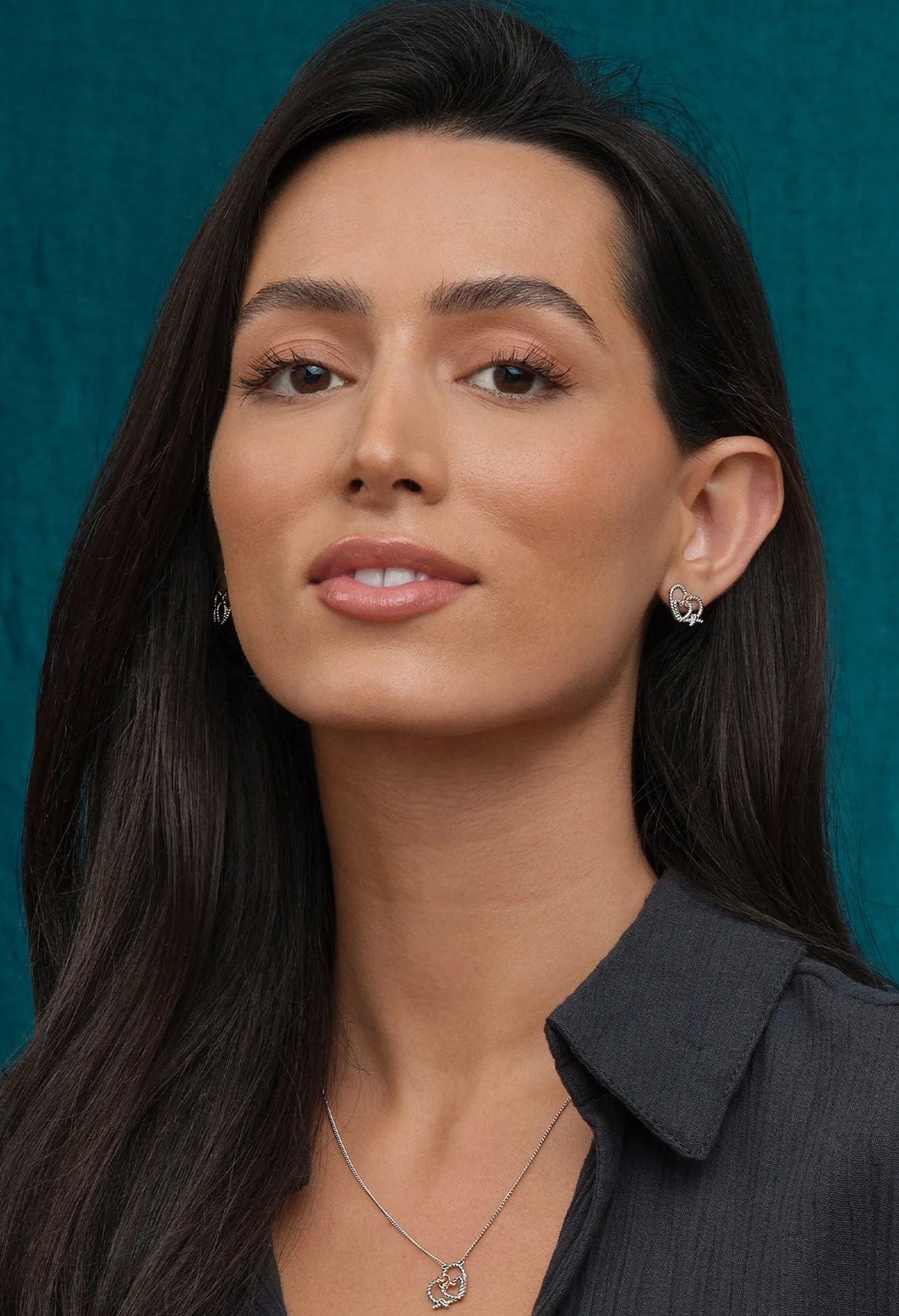 Clogau Bound Earrings detail; silver heart entwined with rose gold Welsh gold, showcasing the jewelry design.