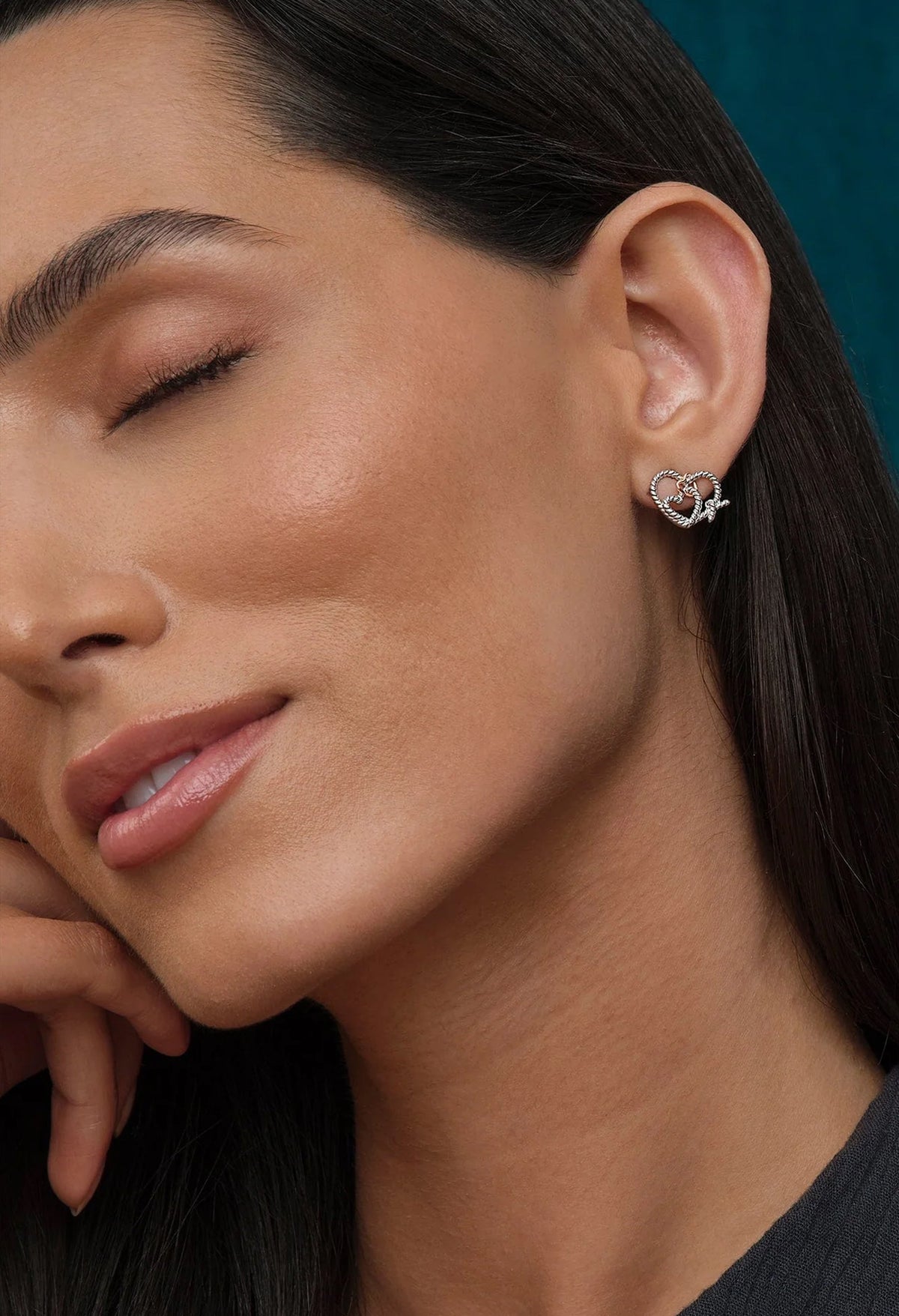 Woman wearing Clogau Bound Earrings featuring a sterling silver and Welsh rose gold design.