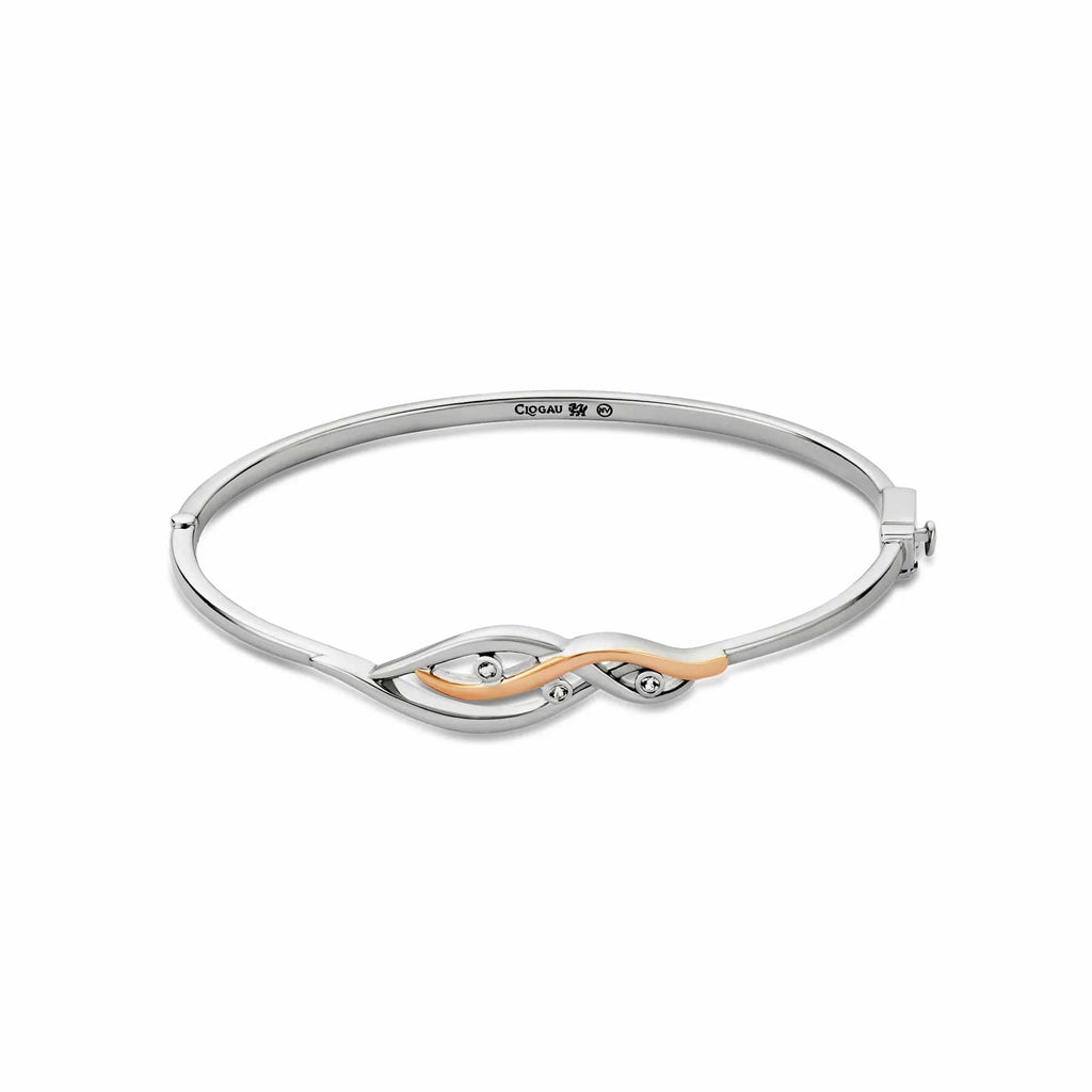 Silver bangle bracelet with rose gold detail and gemstones.
